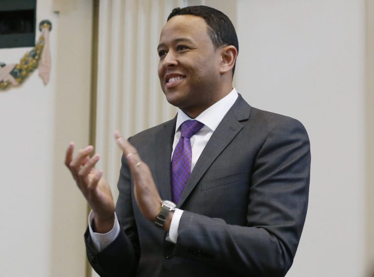 T.W. Shannon applauds during a joint session of the Oklahoma House and Senate in Oklahoma City, Monday, Feb. 3, 2014. (AP Photo/Sue Ogrocki)