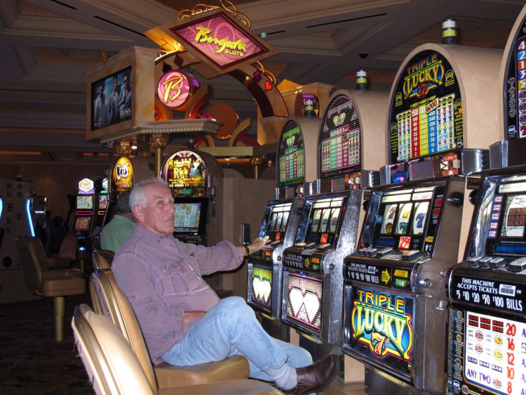 In this June 26, 2013 photo, a man plays the slot machines at the Borgata Hotel Casino & Spa in Atlantic City N.J.A Fairleigh Dickinson University poll released June 16, 2014 shows that 57 percent of New Jerseyans would continue to gamble in Atlantic City once four new casinos are open in New York, with 12 percent planning to take their business to New York.(AP Photo/Wayne Parry)