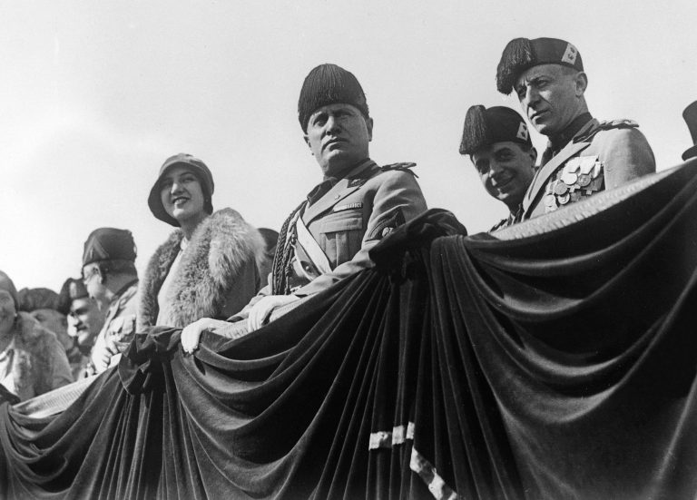 Prime Minister of Italy Benito Mussolini, watches a parade on Oct. 22, 1928. During World War I, plenty of government and industry leaders in America fantasized about state-controlled industry, where we set aside such "destructive" and "irrational" practices like competition. In the decades that followed, this idea took hold most firmly in fascist Italy. (AP Photo)