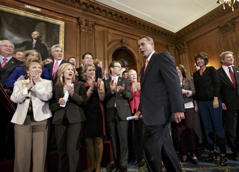 In this Sept. 20, 2013, photo, House Speaker John Boehner is cheered by Republican members of the House of Representatives after passing a bill that would prevent a government shutdown while crippling the health care law that was the signature accomplishment of President Barack Obama's first term, at the Capitol in Washington. Political gridlock in Washington may bring the government itself to a halt next week, as two new polls reflect a broad desire among the public for compromise. Both the Pew Research Center and Gallup released polls showing majorities of Americans in favor of compromise, both the overall principle and the specific example of striking a deal on the budget by politicians who reflect 