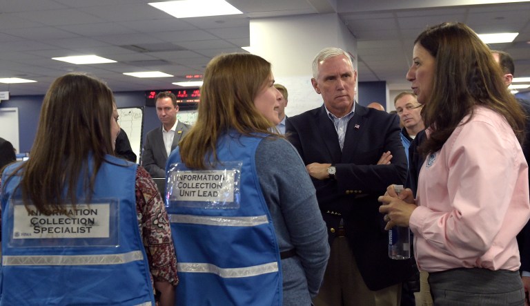 Vice President Mike Pence, center, listens as Homeland Security Acting Secretary Elaine Duke speaks with workers. Duke asked for the first time in history that all federal agencies contribute staff and expertise to the DHS Surge Capacity Force. (AP Photo/Susan Walsh)
