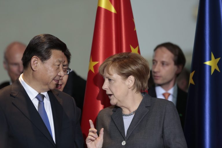 German Chancellor Angela Merkel, right, talks to Chinese President Xi Jinping during a signing ceremony of various contracts between Germany and China at the chancellery in Berlin, Germany, Friday, March 28, 2014. (AP Photo/Markus Schreiber, Pool)