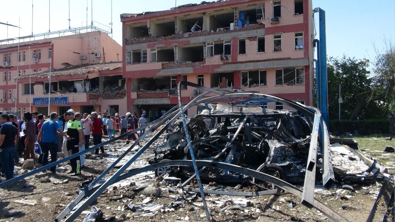 Turkish authorities search outside the damaged building of the police headquarters after an explosion in Elazig, eastern Turkey, on Thursday, Aug. 18, 2016. (Sahismail Gezici/DHA via AP)