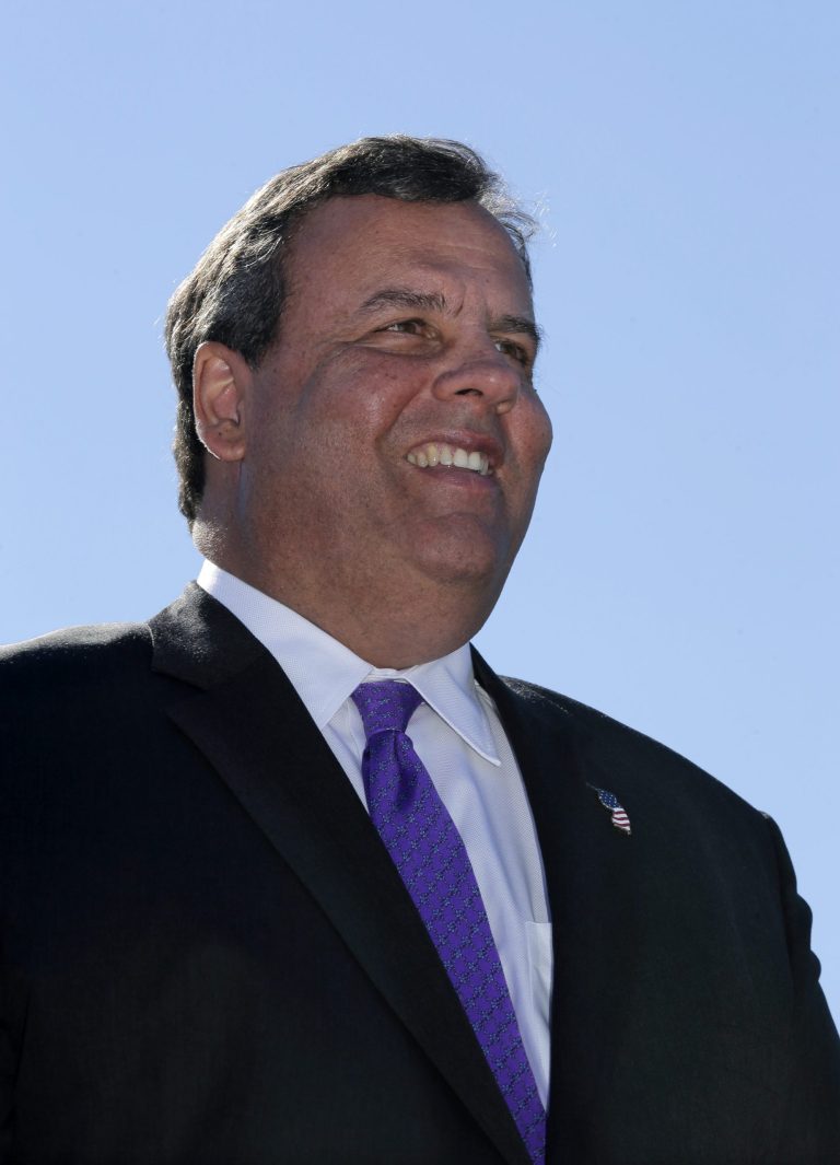 Republican Gov. Chris Christie stands at a gathering in Hillsborough, N.J., Monday, Oct. 28, 2013, to open a stretch of highway named for Peter J. Biondi, who was an Assemblyman from 1998 until his death in 2011. Christie will face Democratic candidate, Barbara Buono in an election Tuesday, Nov. 5, 2013. (AP Photo/Mel Evans)