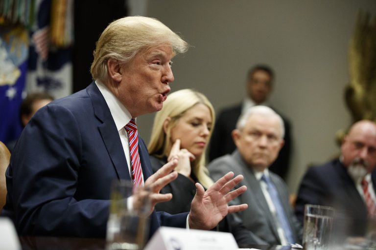 Florida Attorney General Pam Bondi, center, and Attorney General Jeff Sessions, right, look on as President Donald Trump speaks during a meeting with state and local officials to discuss school safety and Hollywood violence, in the Roosevelt Room of the White House, Thursday, Feb. 22, 2018, in Washington. (AP Photo/Evan Vucci)