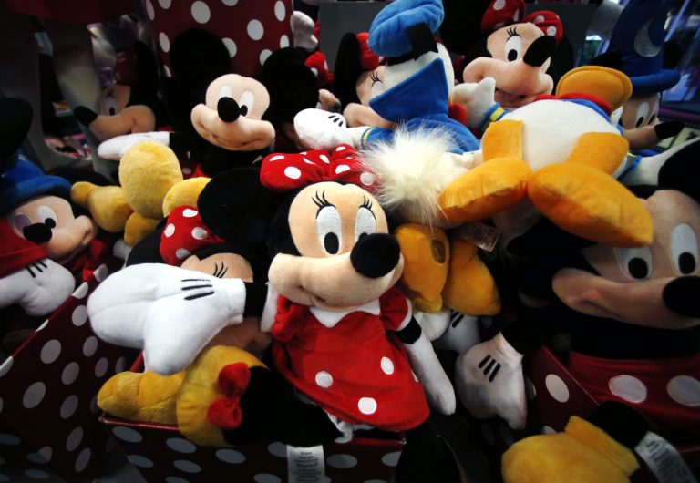 This Jan. 31, 2014, photo shows plush Disney characters piled up in a display at a Disney Store in Saugus, Massachusetts. Disney reports quarterly earnings on Tuesday, May 6, 2014.