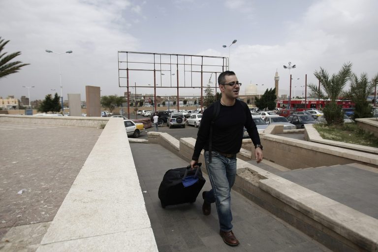 A traveler walks to the departure lounge at Sanaa International Airport in Yemen, Tuesday, Aug. 6, 2013. (AP Photo)Â 