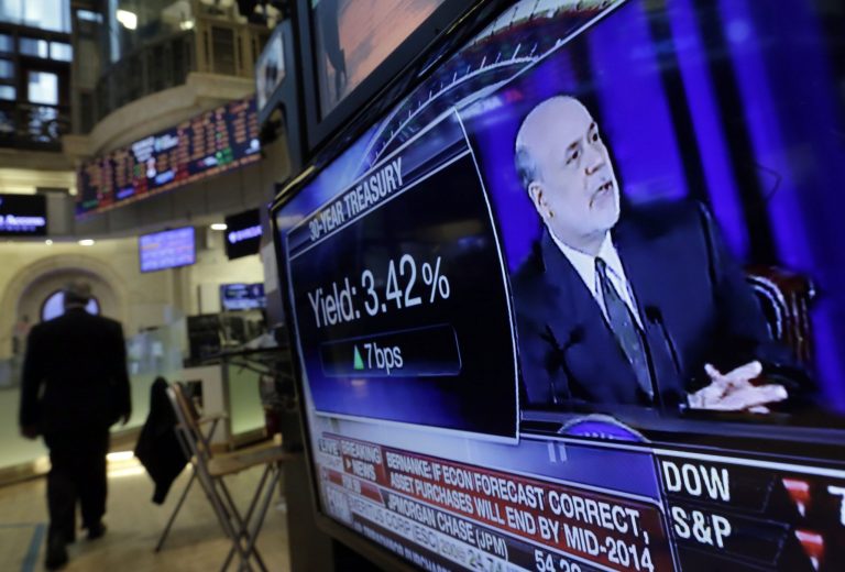 Fed Chairman Ben Bernanke's news conference is on a television screen on the floor of the New York Stock Exchange Wednesday, June 19, 2013.  The Federal Reserve offered a hint Wednesday that it's moving closer to slowing its bond-buying program, which is intended to keep long-term interest rates at record lows. (AP Photo/Richard Drew)