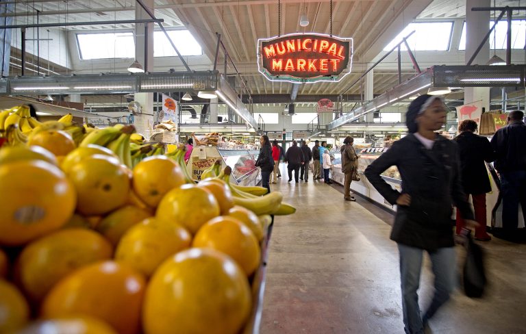FILE - This Dec. 20, 2013 file photo shows shoppers passing through the Sweet Auburn Curb Market in Atlanta. Look no further than your dinner plate to understand how the sweeping farm bill affects you. About 15 percent of the money in the new law, signed by President Obama Friday, will go to farmers to help them grow the food you eat. Most of the rest of the money in the almost $100 billion-a-year law will go to food stamps that help people buy groceries.  (AP Photo/David Goldman, File)