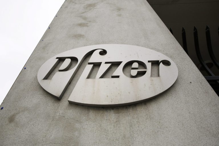 This May 4, 2014 photo shows the Pfizer logo on the exterior of a former Pfizer factory, in the Brooklyn borough of New York. The pharmaceutical giant reports quarterly financial results on Tuesday, July 29, 2014.
