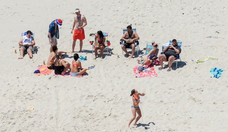 New Jersey Gov. Chris Christie, right, uses the beach with his family and friends at the governor's summer house at Island Beach State Park in New Jersey. Beaches and parks reopened for the Fourth of July holiday after the state reached a budget deal (Andrew Mills/NJ Advance Media via AP)