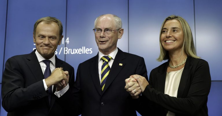 European Council President Herman Van Rompuy, center, holds the hands of Polish Prime Minister Donald Tusk, left, and Italian Foreign Minister Federica Mogherini during a media conference at an EU summit in Brussels, Saturday, Aug. 30, 2014. European Union leaders have nominated Italy's Mogherini to become the 28-nation bloc's new foreign policy chief for the next five years. The EU leaders also elected Polish Prime Minister Donald Tusk to succeed European Council President Herman Van Rompuy in December as EU summit chairman and behind-the-scenes broker of compromises among national leaders. (AP Photo/Yves Logghe)