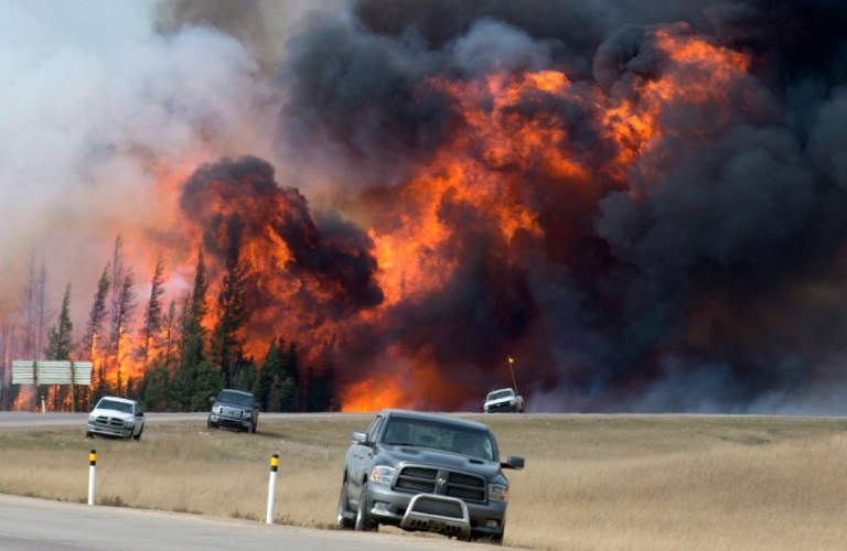Oil companies have shut down production as families are evacuated from Fort McMurray and as the wildfires pose a risk to oil infrastructure. (AP Photo)