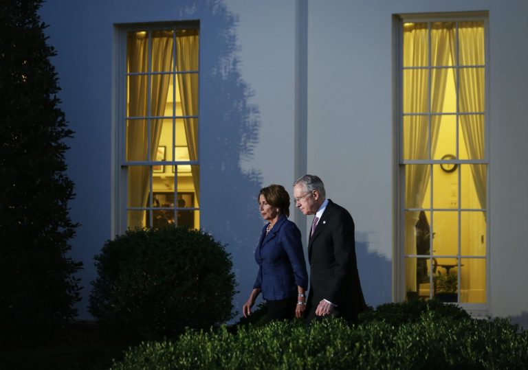 Senate Majority Leader Sen. Harry Reid and House Minority Leader Rep. Nancy Pelosi walk after a meeting with President Obama at the White House on Wednesday evening. (Photo by Alex Wong/Getty Images)