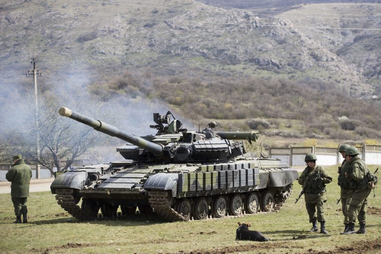 Russian soldiers stand near a tank at a former Ukrainian military base in Perevalne, outside Simferopol, Crimea, March 27. (AP Photo/Pavel Golovkin)