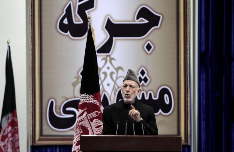Afghan President Hamid Karzai speaks during the first day of the Loya Jirga in Kabul, Afghanistan, Thursday, Nov. 21, 2013. Karzai has told a gathering of elders that he supports signing a security deal with the United States if safety and security conditions are met. Karzai spoke as the 2,500-member national consultative council of Afghan elders known as the Loya Jirga started in Kabul on Thursday. The four-day meeting will discuss the bilateral security pact that defines the role of thousands of U.S. troops who will remain after the NATO combat mission ends in 2014. (AP Photo/Rahmat Gul)