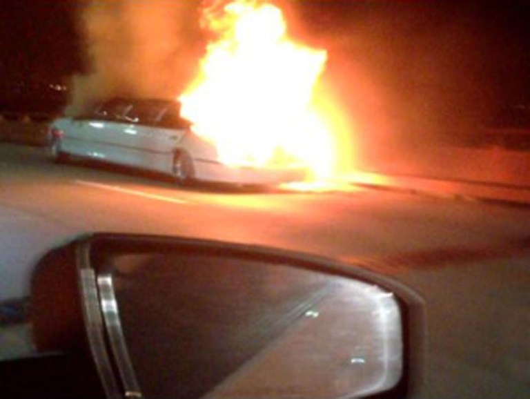 This frame grab taken from video provided by Roxana and Carlos Guzman shows a Limo on fire Saturday, May 4, 2013, on the San Mateo-Hayward Bridge in San Francisco. Five dead female bodies were found pressed up against the partition behind the driver, where they apparently tried to escape the smoke and fire that kept them from the rear exits of the extended passenger compartment. (AP Photo/Roxana and Carlos Guzman)