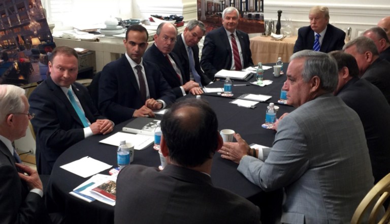 George Papadopoulos, third from left, sits at a table with then-candidate Trump and others at what is labeled at a national security meeting. Papadopoulos, a former Trump campaign aide pleaded guilty and provided evidence in the first criminal case that connects Trump's team and intermediaries for Russia seeking to interfere in the campaign. (Donald Trump's Twitter account via AP)