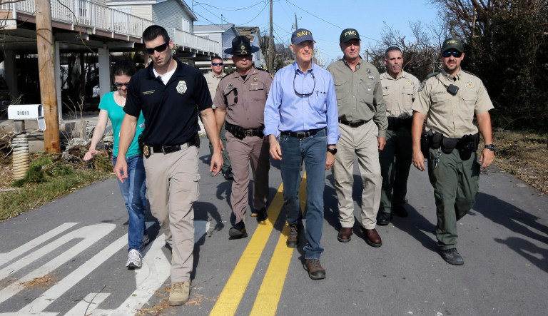 Gov. Rick Scott, center, assesses the damages in the aftermath of Hurricane Irma. A nursing home's officials said they called an emergency cellphone number connected to Scott's office making a request for help 36 hours before patients began to die. (AP Photo/Alan Diaz, File)