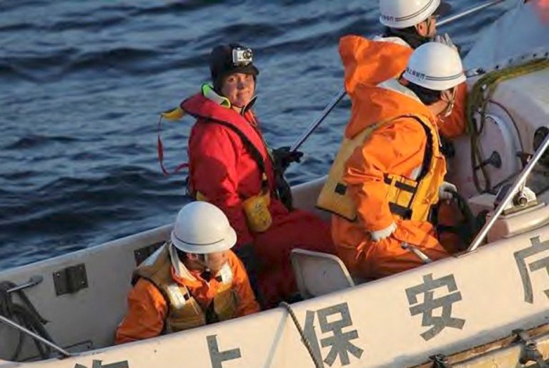   CORRECTS DATE - In this photo released by Japan Coast Guard, British adventurer Sarah Outen, facing camera, stands in a boat after she was rescued by Japan Coast Guard in the Pacific Ocean off northeastern coast of Japan, Friday, June 8, 2012. The Japanese coast guard on Friday rescued Outen who hit a storm while rowing solo across the Pacific. Another Briton on a similar trek was still awaiting rescue. (AP Photo/Japan Coast Guard) EDITORIAL USE ONLY  
