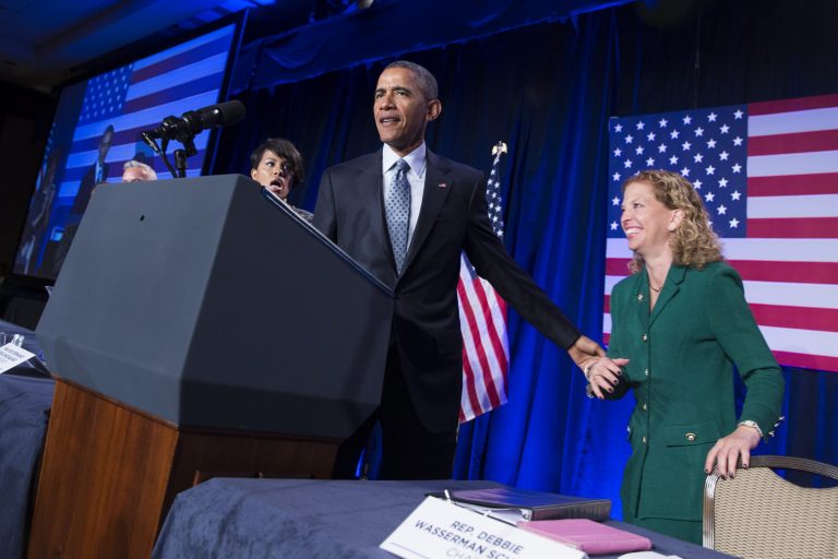 President Barack Obama greets Democratic National Committee Chair Rep. Debbie Wasserman Schultz, D-Fla., before speaking at the Democratic National Committee winter meeting in Washington, Friday, Feb. 20, 2015. (AP Photo/Evan Vucci)
