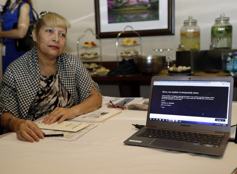 A woman waits to talk to a navigator about health care options available under the Affordable Care Act at the North Shore Medical Center in Miami on Nov. 19. (AP Photo/Lynne Sladky)