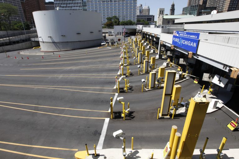 FILE - This July 12, 2012 file photo show the lanes entering the United States at the Detroit Windsor Tunnel. Detroit has reached a tentative deal to pay a key creditor 26 cents on the dollar and offer it valuable leases, a move that that could clear the biggest hurdle in the city's plan to reduce its debts and emerge from bankruptcy protection. A joint court filing Tuesday evening, Sept. 9, 2014 said Detroit and the bond insurer Syncora Guarantee 