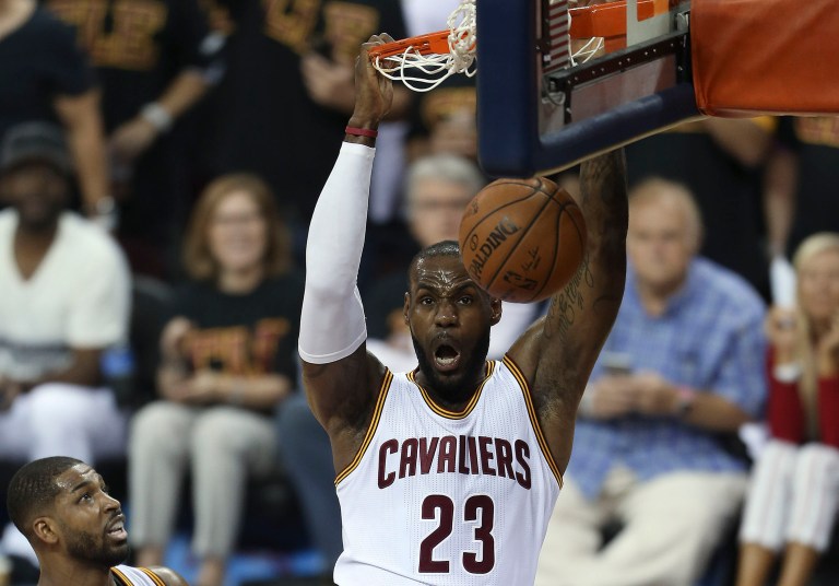 A picture of Cleveland Cavaliers' player Lebron James will be removed from the side of the Sherwin-Williams AmEx building before Republican National Convention. (AP Photo/Ron Schwane)