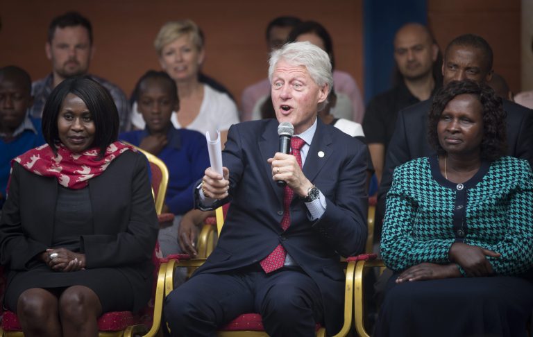 Former President Bill Clinton, center, responds to a question from a pupil asking how the Clinton Foundation was started, as he and Chelsea Clinton talk about their foundation's 