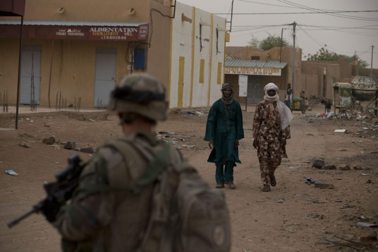 A French soldier patrols in a central market in Kidal, Mali, at dusk on July 27. (AP Photo/Rebecca Blackwell)