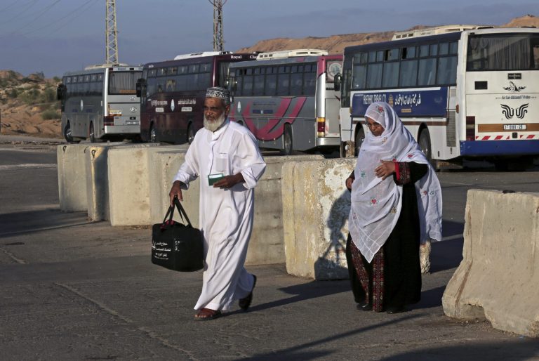 Palestinian pilgrims cross the Beit Hanoun checkpoint on their way to the Erez border crossing between Israel and Gaza and then to Jerusalem, during the three-day Muslim holiday of Eid al-Adha, in the northern Gaza Strip, Sunday, Oct. 5, 2014. In a rare gesture, Israeli authorities relaxed restrictions and allowed 550 Palestinian pilgrims to cross into Israel from Gaza to pray at the al-Aqsa mosque in Jerusalem. The men had to be over 60 years old. (AP Photo/Adel Hana)