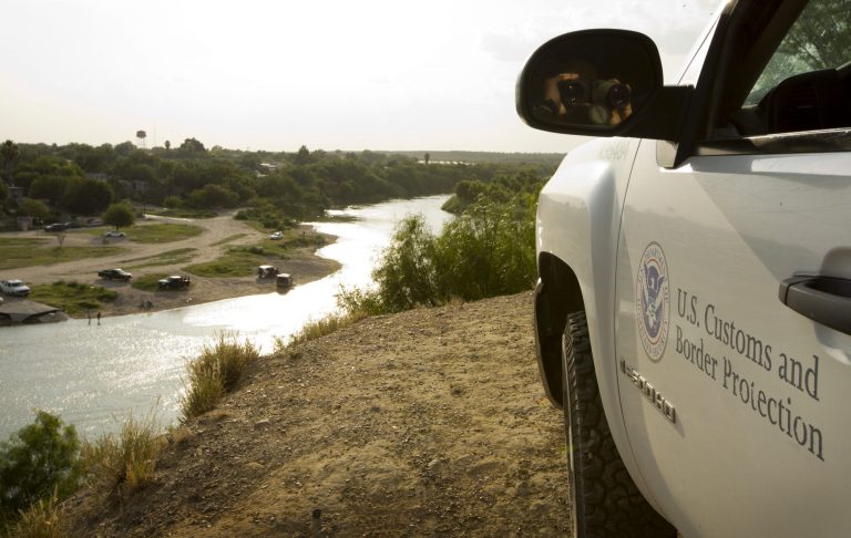 A U.S. Border Patrol agent keeps watch in Roma, Texas, across the Rio Grande River from Ciudad Miguel Aleman, Tamaulipas, Mexico, in this July 23, 2014 photo. (AP Photo/Austin American-Statesman, Jay Janner)