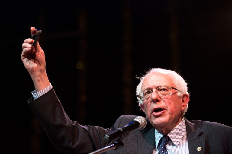 Democratic presidential candidate Sen. Bernie Sanders holds up his cell phone as he speaks about citizens' ability to record police-officer involved interactions during a campaign stop in Chicago. (Erin Hooley/Chicago Tribune via AP)