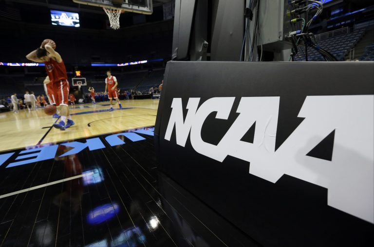 American University players warm up during a practice session for their NCAA college basketball tournament game Wednesday, March 19, 2014, in Milwaukee. American plays Wisconsin in round two on Thursday. (AP Photo/Morry Gash)