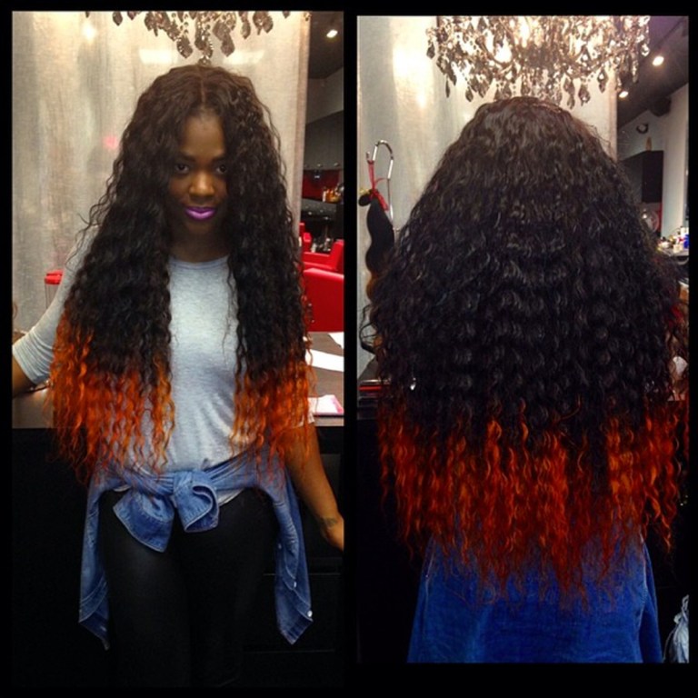 In this undated image provided by Miranda Jade Plater and posted in April 2014 to the Instagram account of her company, Limelight Extensions, Plater poses wearing long, black curly hair extensions with the ends dyed bright orange at her salon in Farmington Hills, Mich. This photo alone has generated about $10,000 in sales. (AP Photo/Courtesy Miranda Jade Plater)