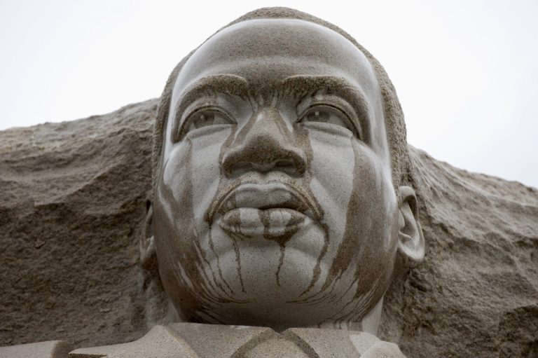 Rain runs down the face of the Martin Luther King Jr. Memorial in Washington, Tuesday, Aug. 13, 2013. Work to refinish part of the Martin Luther King Jr. Memorial where a disputed inscription was recently removed may not be done until after the 50th anniversary of the March on Washington. (AP Photo/Carolyn Kaster)