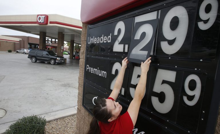 Quick Trip clerk adjusts the gas price sign numbers at a QT convenient store as gas prices continue to tumble nationwide. Motorists are now seeing prices under $3 a gallon for the first time in four years, which also means that gas stations are paying less for the fuel, too. (AP Photo/Ross D. Franklin)