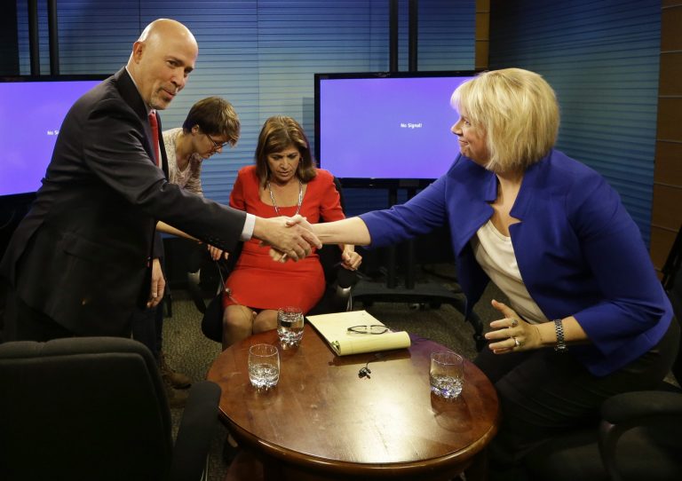 Republican Tom MacArthur, left, and Democrat Aimee Belgard shake hands as the candidates in New Jersey's contentious and close 3rd Congressional District race arrive to answer questions in joint interview on NJTV with host Marie DeNoia Aronsohn, center, in Trenton, N.J. on Friday. TheÂ Democratic Congressional Campaign Committee yanked a television that falsely linked MacArthur to a lawsuit filed by Arizona firefighters.Â (AP Photo/Mel Evans)