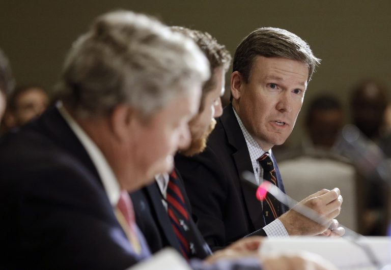 Tony Clark, right, commissioner of the Federal Energy Regulatory Commission, announced via Twitter a week ago that he would not seek another term on the commission. (AP Photo/Mark Humphrey)