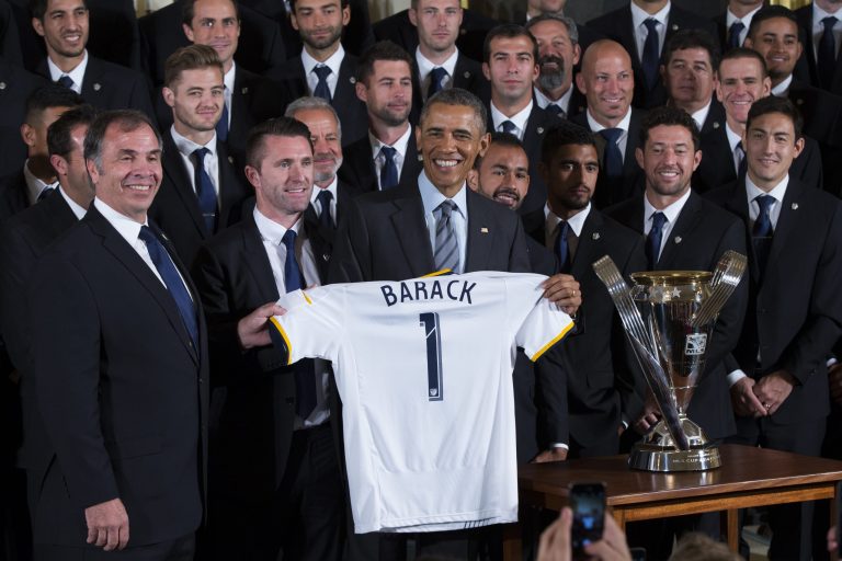 LA Galaxy head coach Bruce Arena, left, and team captain Robbie Keane present President Obama with a jersey during a ceremony to honor both the 2014 NHL Champion Los Angeles Kings and 2014 MLS Cup Champion LA Galaxy in the East Room of the White House, on Monday. (AP/Evan Vucci)