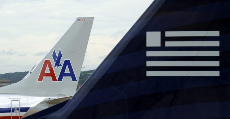 With a proposed merger between US Airways and bankrupt American Airlines grounded by a government-led antitrust lawsuit, the carriers -- backed by a bipartisan group of political allies -- are pressing the Obama administration to allow the deal to fly. (AP Photo/Susan Walsh)