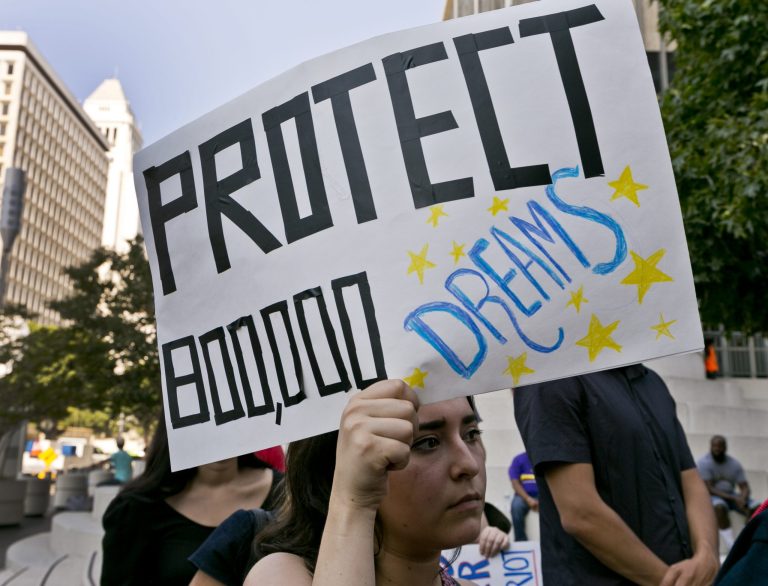 An unidentified student joins a rally in support of the Deferred Action for Childhood Arrivals, or DACA program outside the Edward Roybal Federal Building in downtown Los Angeles Friday, Sept. 1, 2017. President Donald Trump says he'll be announcing a decision on the fate of hundreds of thousands of young immigrants who were brought into the country illegally as children in the coming days, immigrants he's calling 