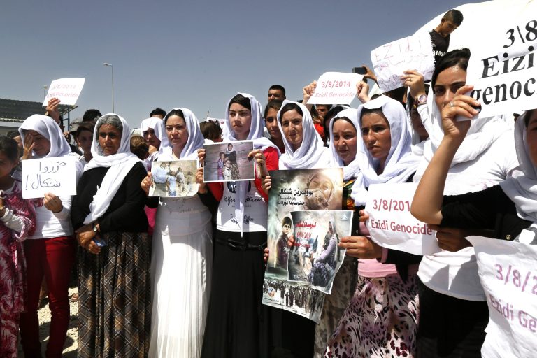Women hold posters during a protest against the Islamic State in Dohuk, northern Iraq, Monday, Aug. 3, 2015. (AP Photo/Seivan M.Salim)