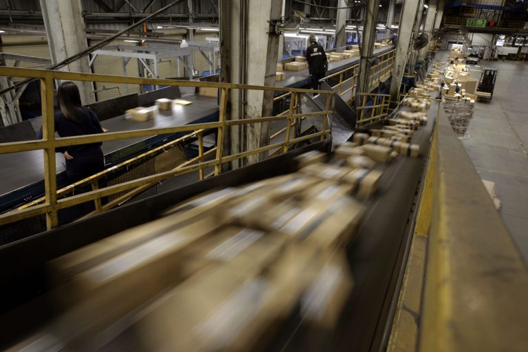 FILE - In this Monday, Dec. 2, 2013 file photo, FedEx Packages move on a conveyor belt at the FedEx hub at Los Angeles International Airport in Los Angeles.  A Federal Reserve survey shows economic growth remained healthy in most U.S. regions in late November and December, helped by gains in consumer spending and factory output. (AP Photo/Jae C. Hong)