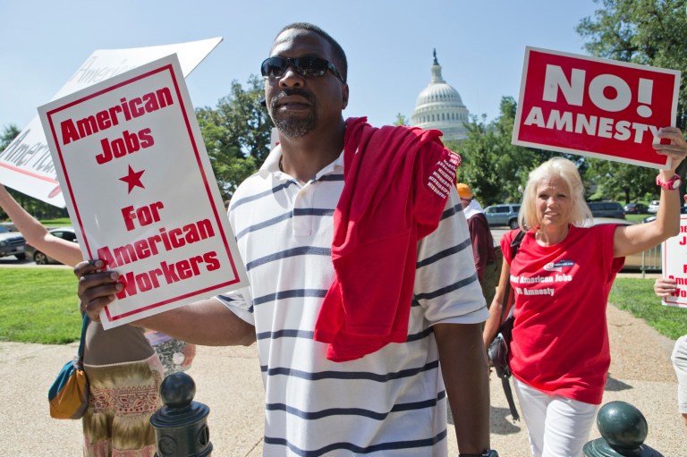 People opposed to immigration reform gather at a rally on Capitol Hill in Washington last July. The event was sponsored by a group called the Black American Leadership Alliance, which, in their words, does not want to 