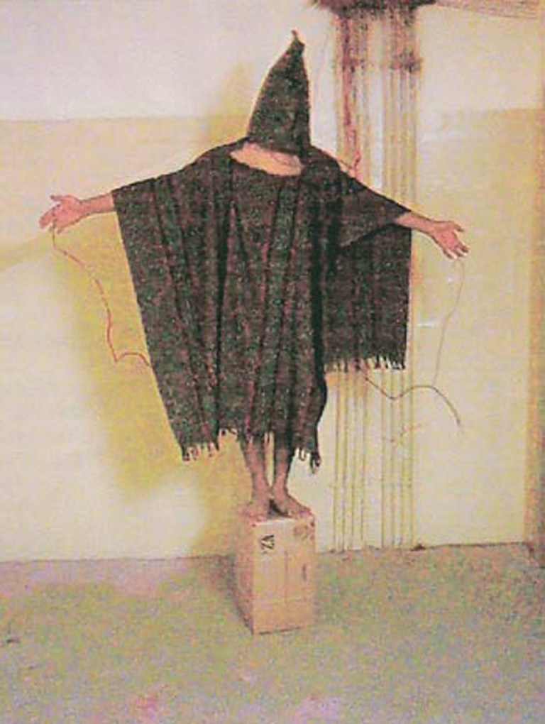 A hooded and wired Iraqi prisoner is seen at the Abu Ghraib prison near Baghdad, Iraq in this undated photo. (AP Photo/Courtesy of The New Yorker)