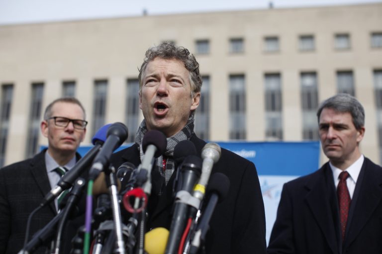 Sen. Rand Paul, R-Ky., center, speak to reporters in front of federal court in Washington on Wednesday. (AP Photo/Charles Dharapak)