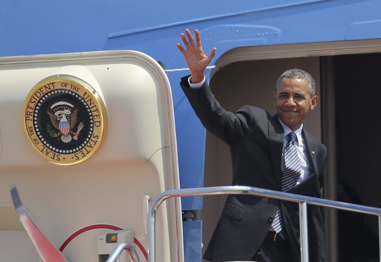 President Barack Obama waves as he boards Air Force One at Haneda Airport in Tokyo, Friday, April 25, 2014, en route to Osan Air Base in Osan, South Korea. (AP Photo/Eugene Hoshiko)