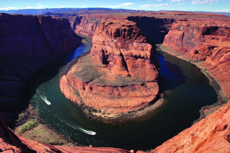 FILE - In this Wednesday, March 5, 2008 file photo, water levels at the Colorado River's Horseshoe Bend begin to rise along the beaches just hours after the Glen Canyon Dam jet tubes began releasing water, in Page, Ariz. Drought, climate change and an increasing population in the West are pushing the Colorado River basin toward deep trouble in the coming decades, scientists say. (AP Photo/Matt York)