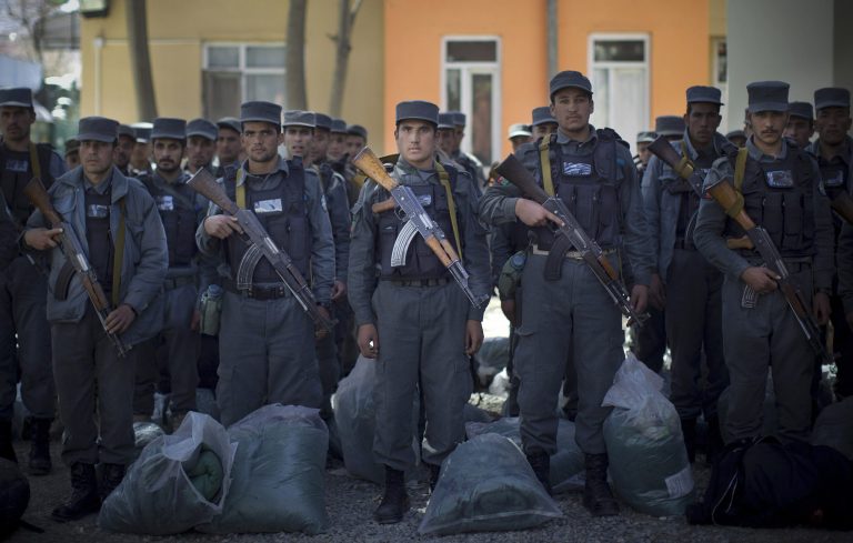 Afghan police recruits who just finished their first training at the police academy, line up as they arrive with their sleeping bags at a police station in Kabul on Sunday, March 30, 2014. (AP Photo/Anja Niedringhaus)